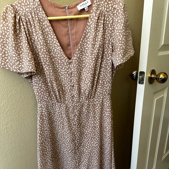 Women midi dress, color is cream nude. Size small with zipper on the back.
